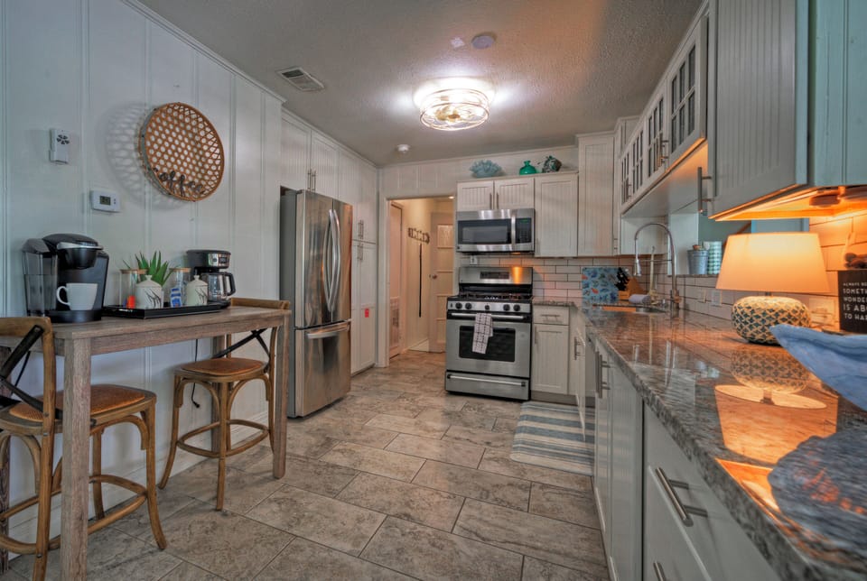 Coastal-inspired kitchen with stainless steel appliances, ample counter space, and everything you need for easy meals at home.