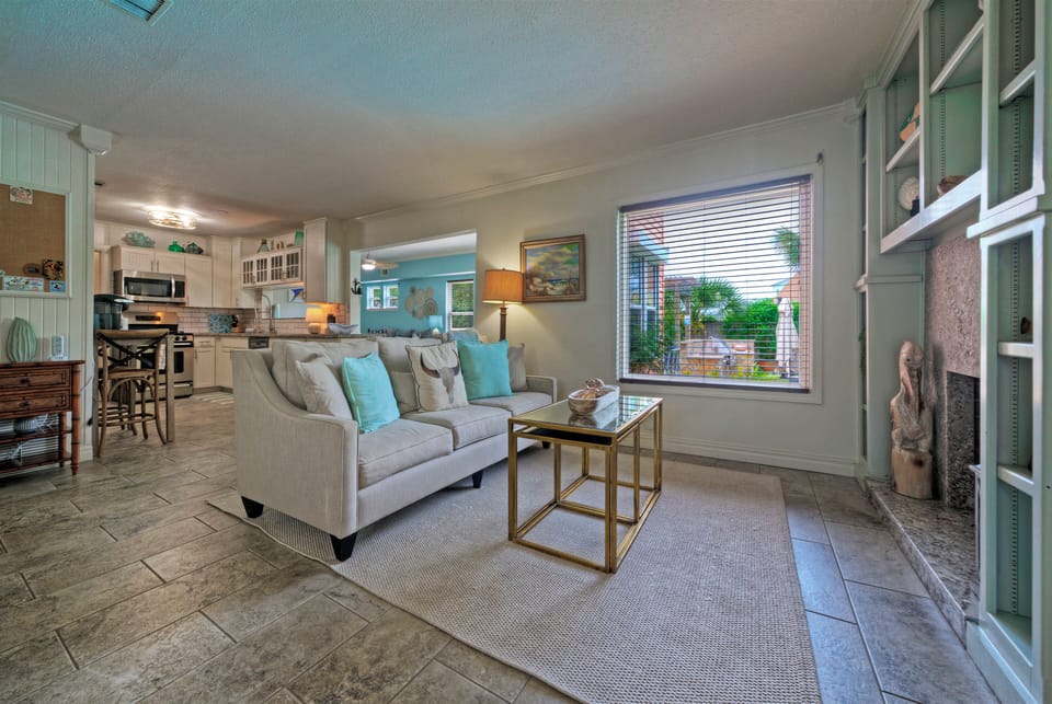 Open living area with coastal decor, cozy seating, and easy flow into the kitchen.