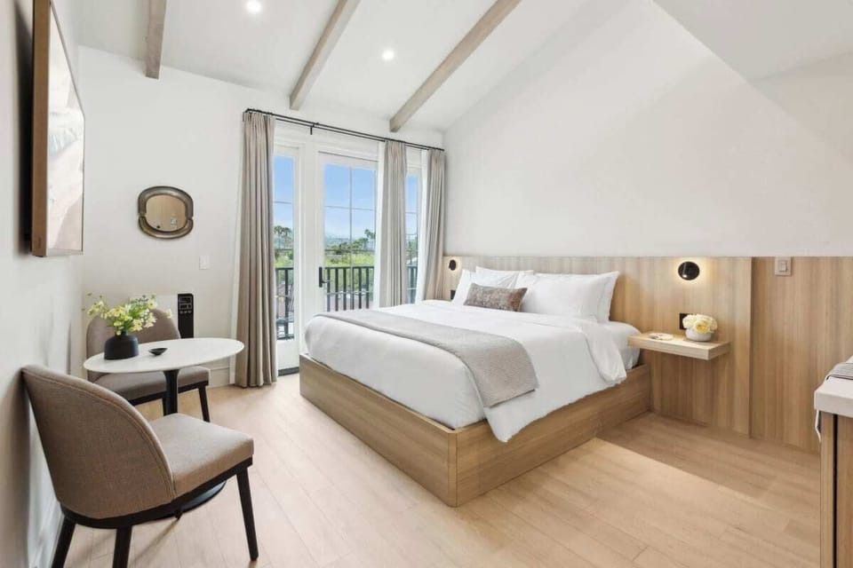 King-size bed, sleeps 2, seating area, and 65" Hisense TV 