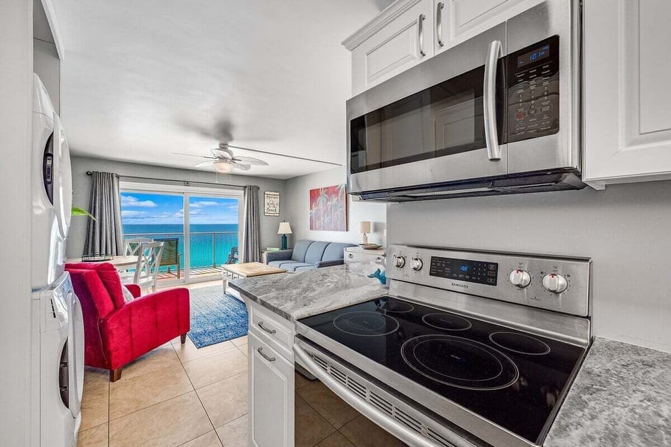 Featuring sleek countertops and modern appliances, the space includes a coffee pot for your morning pick-me-up