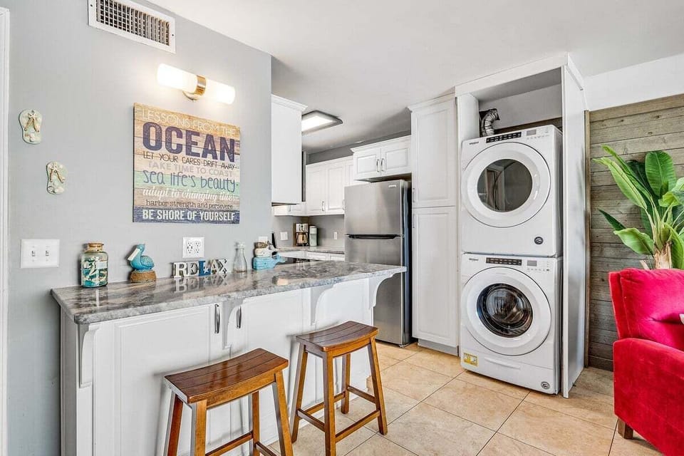 A washer-dryer unit is seamlessly integrated, making long stays even more comfortable.
