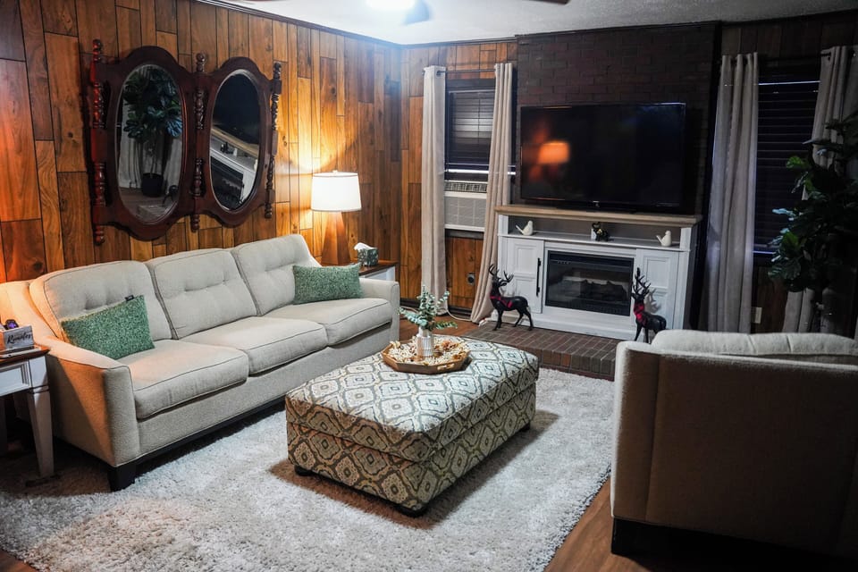 Comfy Living room with 65 inch tv and several books to read.