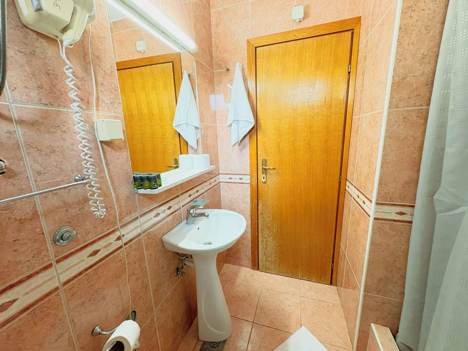 Standard Triple Room, Balcony | Bathroom | Shower, hair dryer, slippers, towels