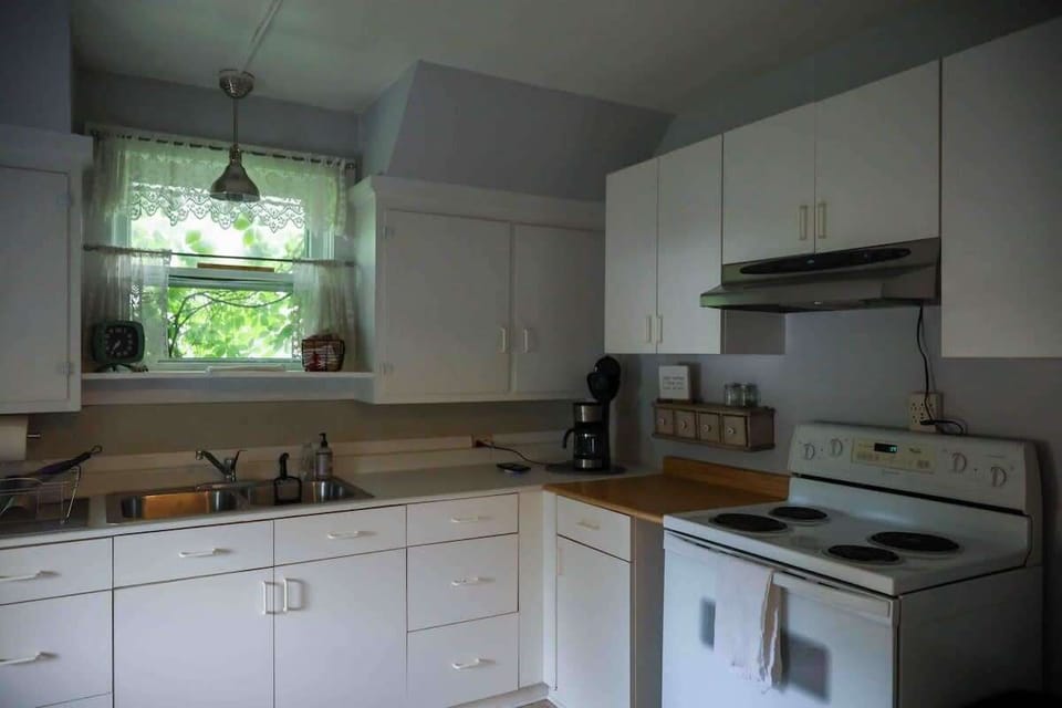 The kitchen has full fridge, oven, microwave coffee maker, and toaster