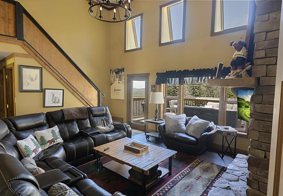 The living room, with ample windows and a fire in the gas fireplace, is the perfect place to unwind.  You can acess the upper deck from this room.