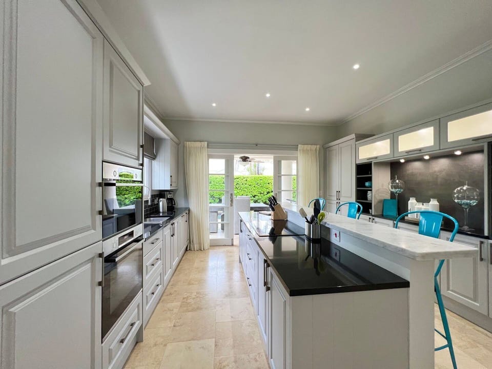 Fully equipped kitchen features modern appliances and a central island, perfect for enjoying a leisurely breakfast