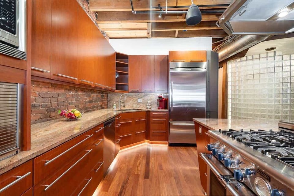 Fully Equipped Kitchen featuring stainless steel, open counter space, and bar seating for 3 guests.