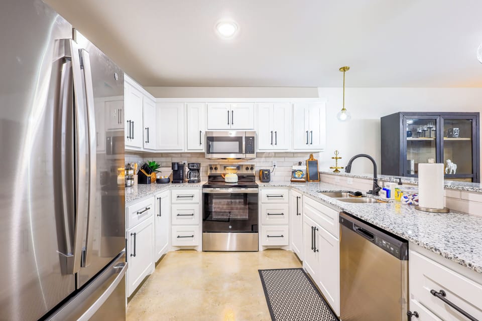 Modern kitchen with stainless steel appliances and granite counters.