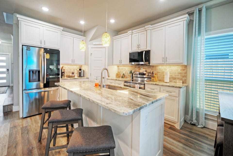 Stylish kitchen with island seating and updated appliances.
