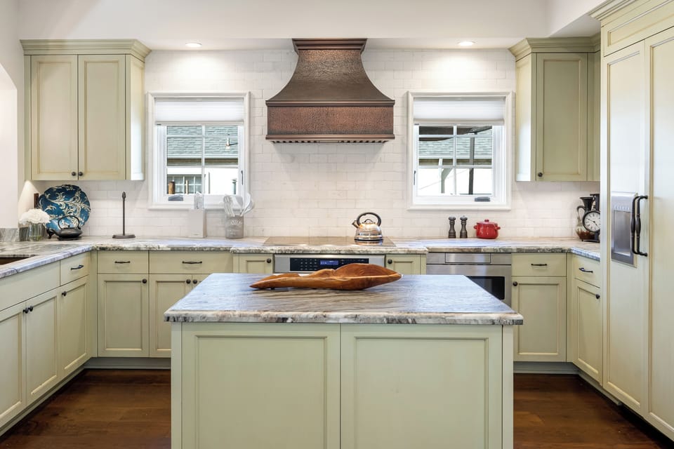 A spacious workspace with a stove and sleek finishes.
