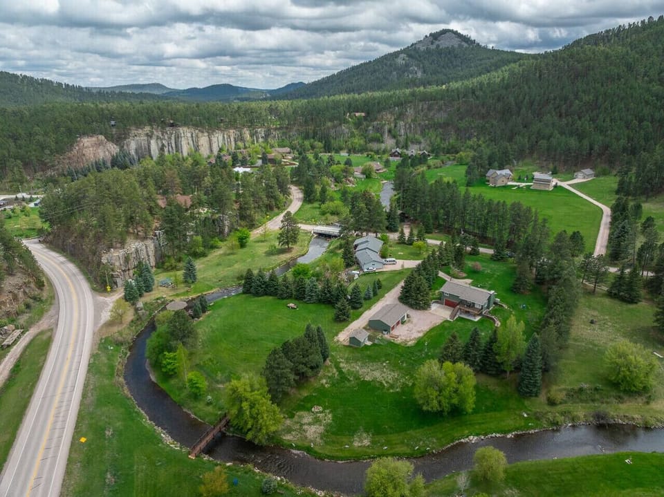 Nestled along Rapid Creek and surrounded by towering pines and scenic cliffs, this peaceful cabin retreat offers a perfect blend of nature, comfort, and Black Hills beauty.