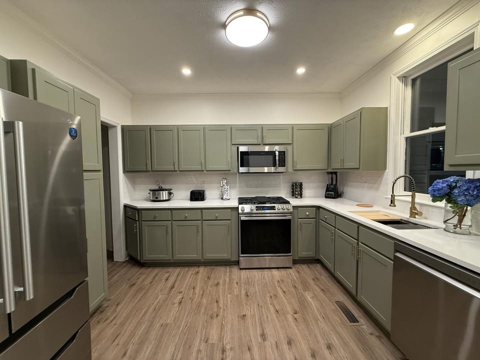 Modern, fully equipped kitchen with sleek cabinets and bright lighting.