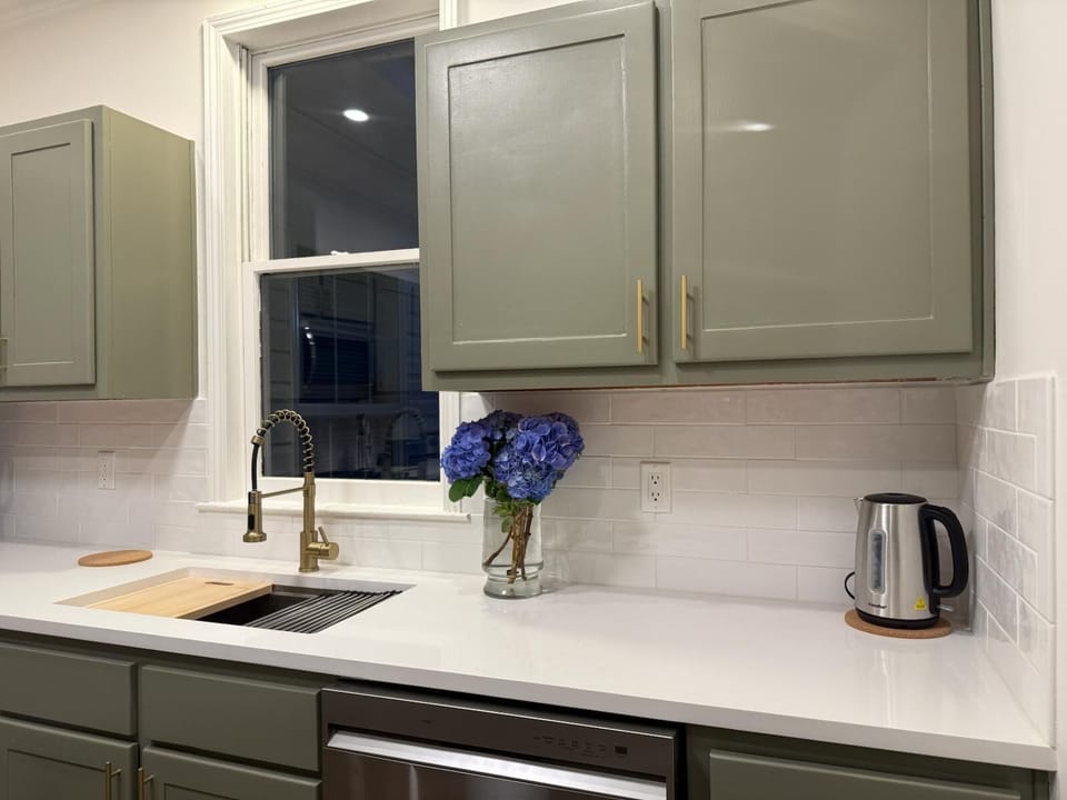 Modern, fully equipped kitchen with sleek cabinets and bright lighting.