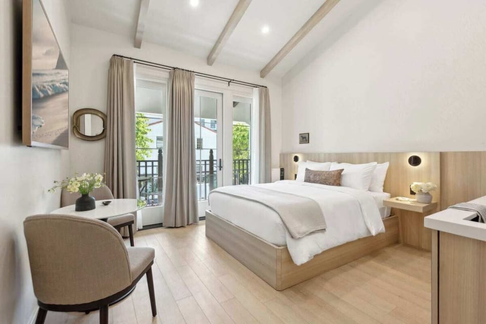 Queen-size bed, sleeps 2, seating area, and 65" Hisense TV 