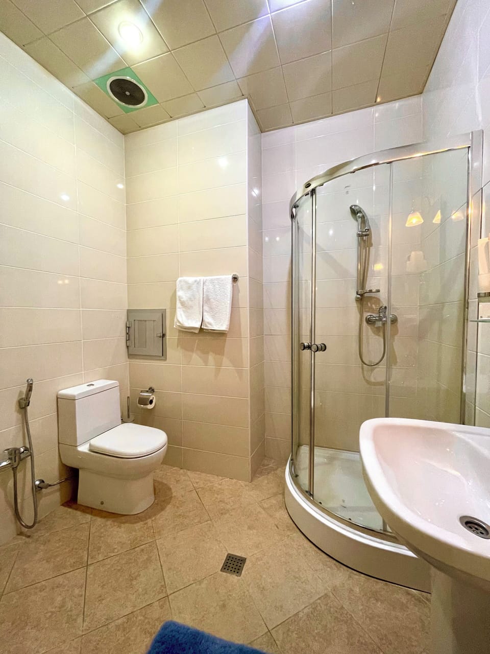 Shower, hair dryer, slippers, towels