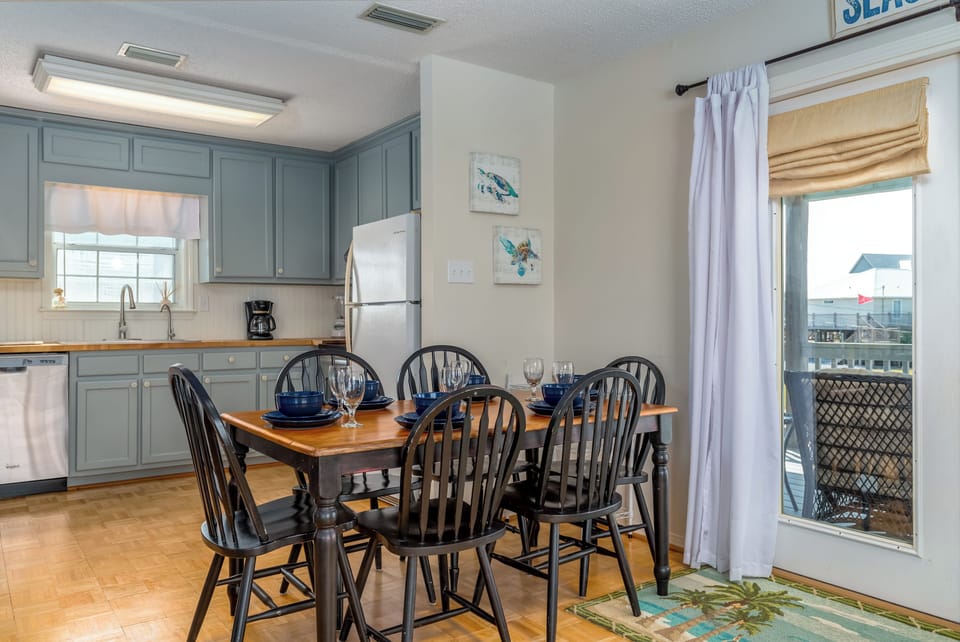 Your spacious kitchen and dining area features coastal charm.