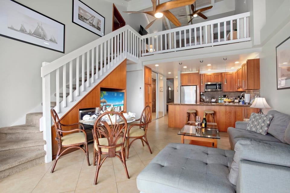 Sailboat prints, a spiral of white stairs, and rattan dining touches make this airy hideaway a charming tropical delight     PKC-403