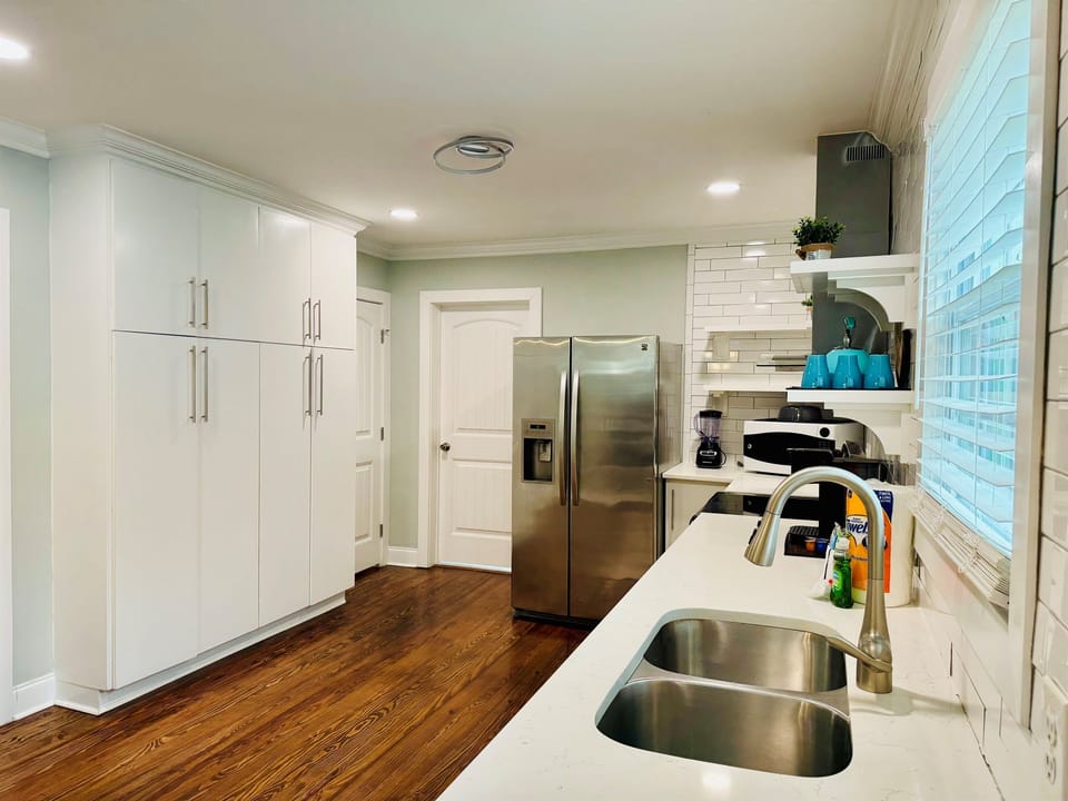 Kitchen includes appliances such as refrigerator, range oven, dishwasher, coffee maker, toaster, Crockpot, blender.