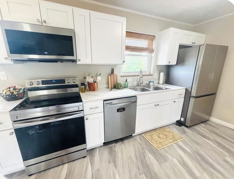 Fully stocked kitchen complete with fridge, dishwasher, stove, oven, microwave.