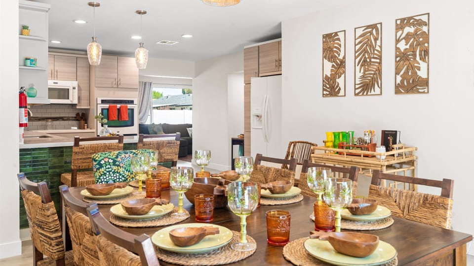 Gather for dinner at the tropical-inspired dining table with textured chargers and tiki-colored glassware.