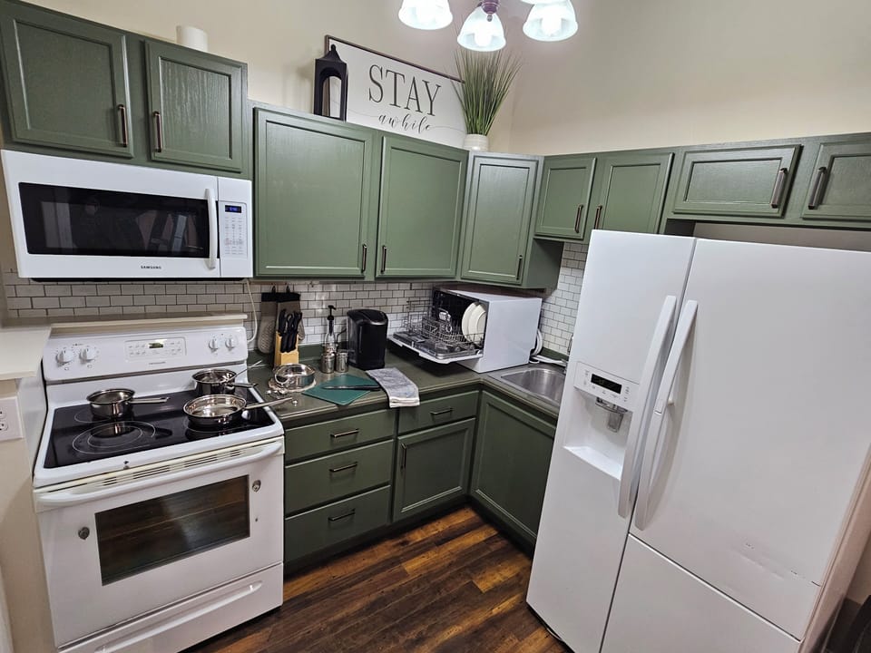 Kitchen With Full Size Refrigerator & Stove - Pots and Pans and Dishwasher