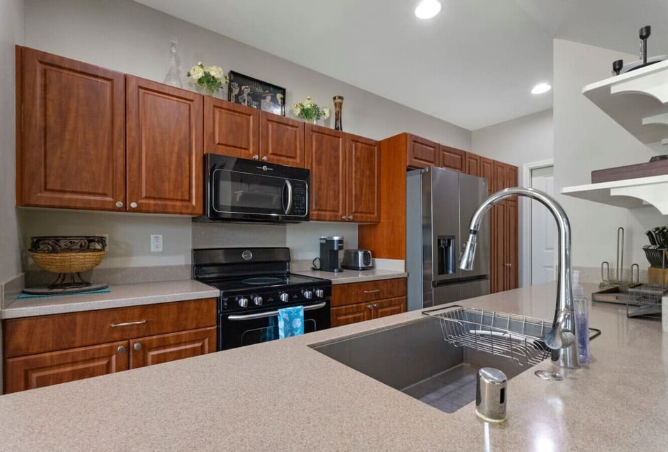 Spacious, well-equipped kitchen featuring modern appliances, ample counter space, and warm wood cabinetry—perfect for cooking and gathering.