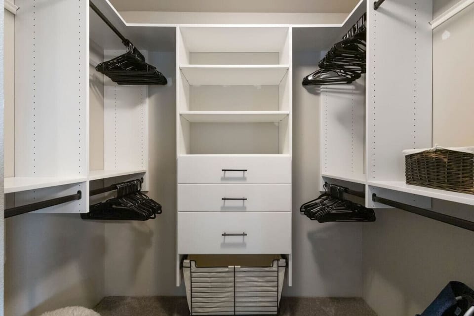 Spacious walk-in closet with built-in shelving and ample hanging space—perfect for staying organized throughout your stay.