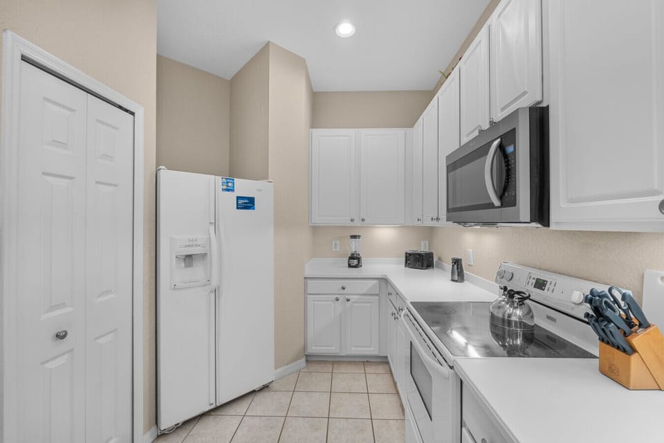 Featuring a variety of home appliances, this kitchen is equipped to make cooking easy and enjoyable.