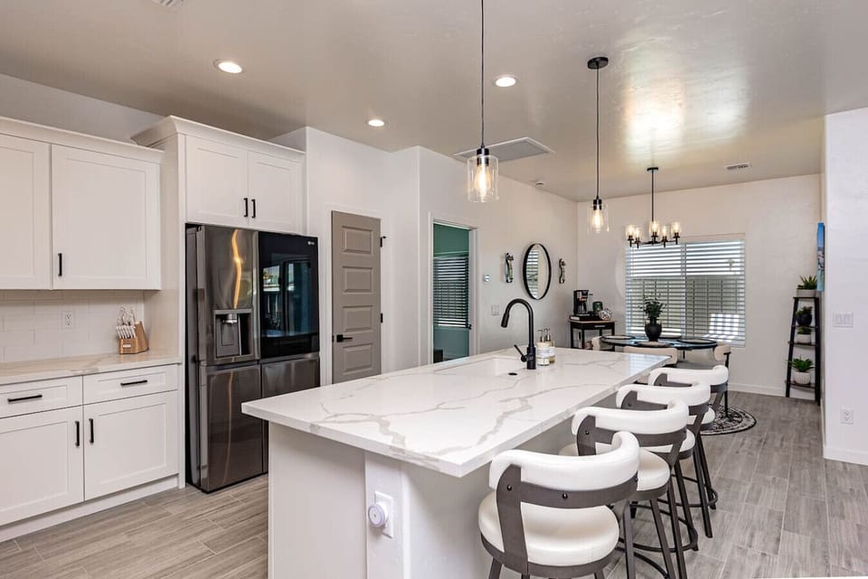 Fully stocked kitchen with everything you need, plus barstool seating for four at the island—perfect for casual meals or morning coffee.