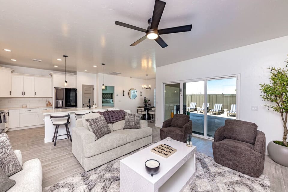 Open-concept living room with comfy couch seating, Smart TV, and a queen pullout for extra sleeping space.