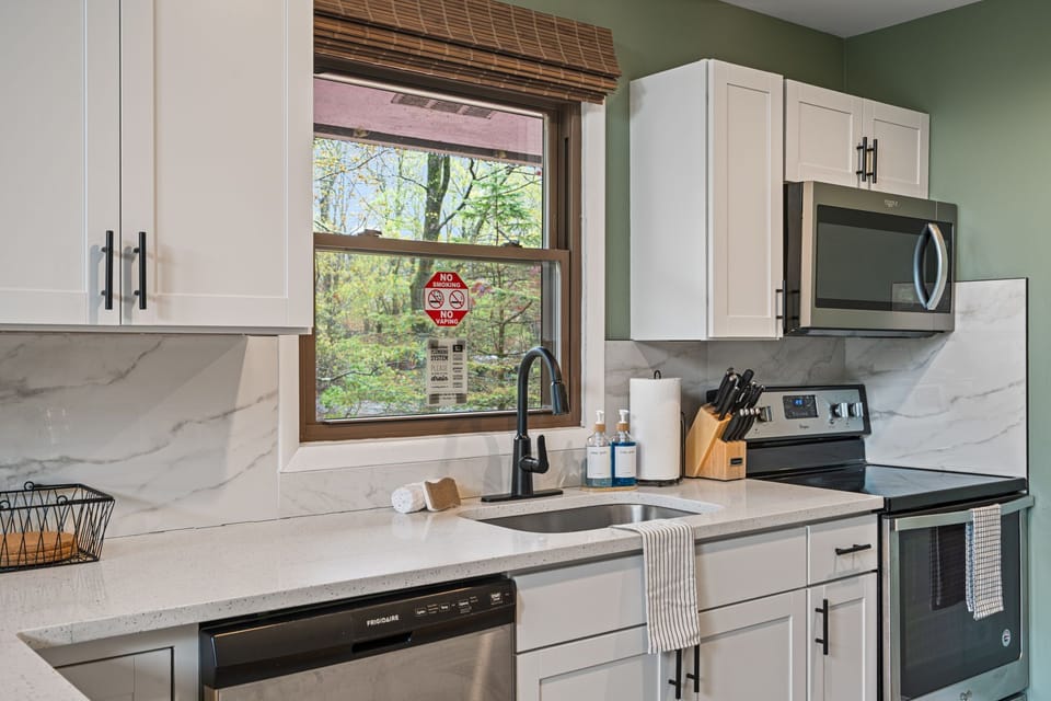 Updated kitchen with stove, dishwasher, and microwave.