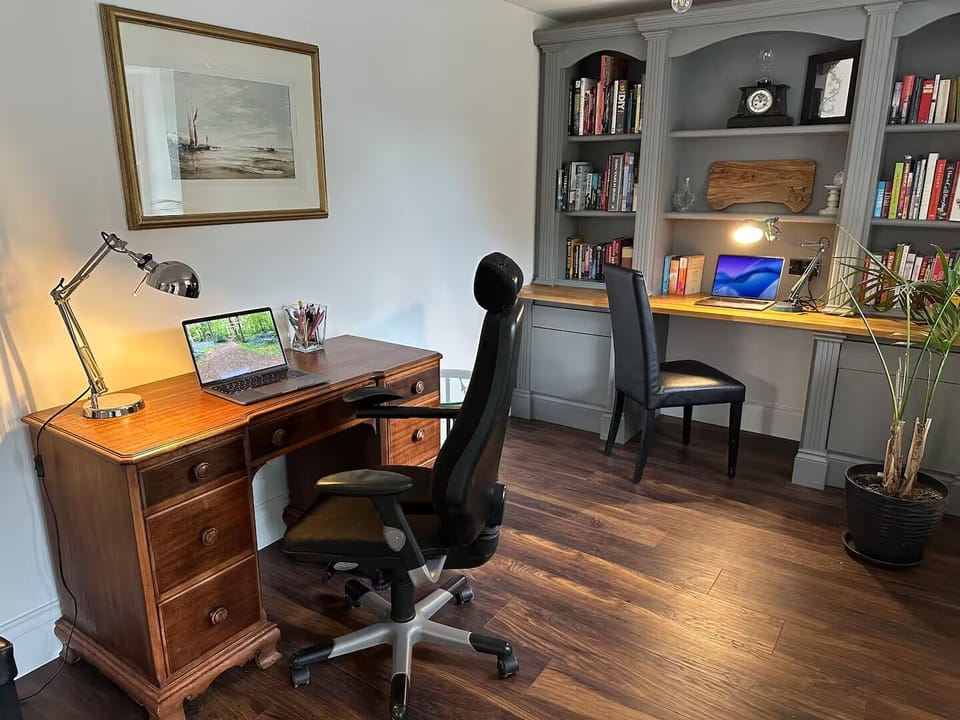 Sun-lit office with 2 desks, library & garden views – perfect for creative work!