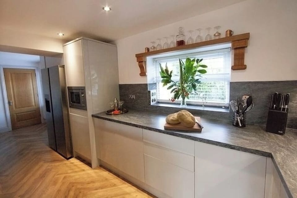 Marble island, ample worktops & professional range make catering seamless.
