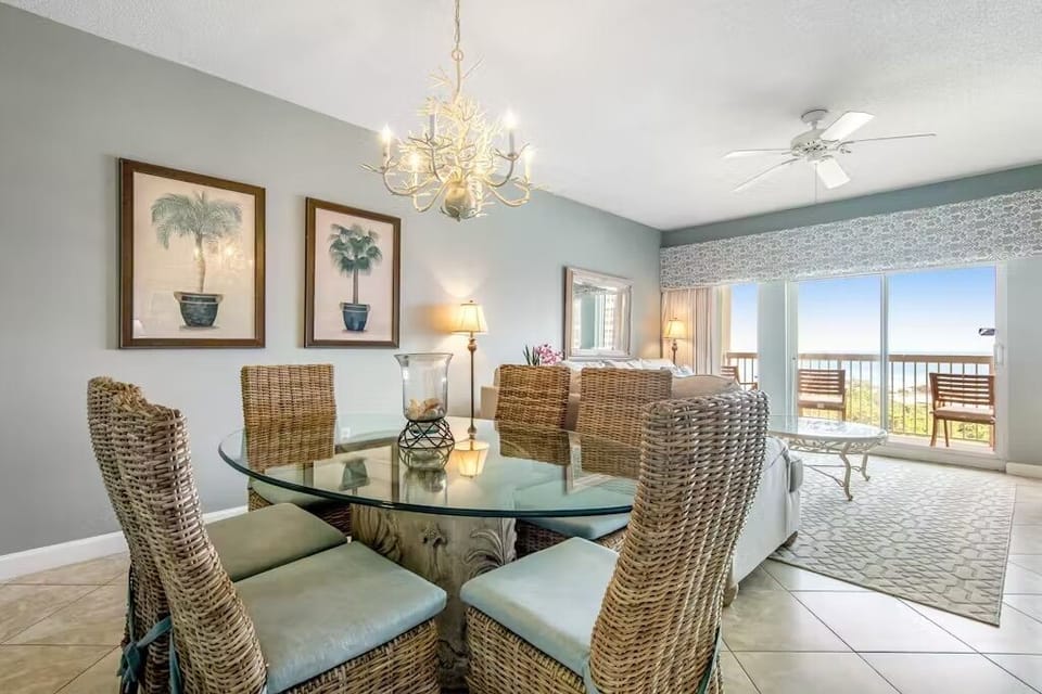 Gather around your elegant dining table while enjoying ocean views through sliding glass doors that lead to your private balcony retreat.