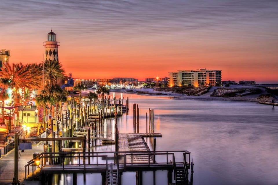 Stunning waterfront views featuring the iconic lighthouse and marina at sunset, showcasing the beautiful coastal location.