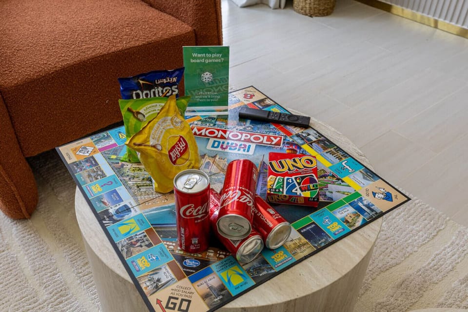 Game night setup with Monopoly, UNO, snacks, and drinks.