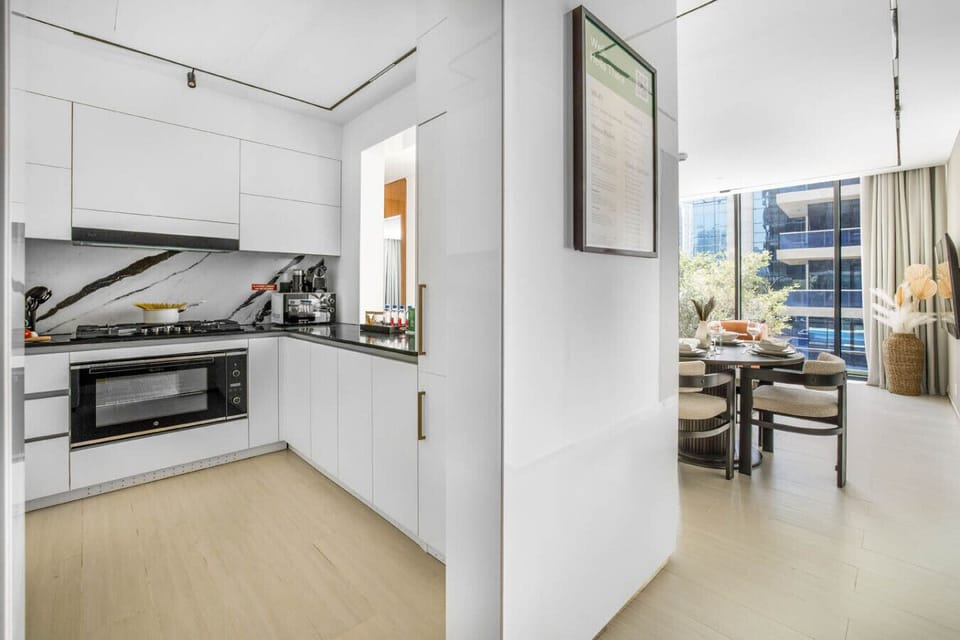 Sleek kitchen with built-in appliances and coffee machine.