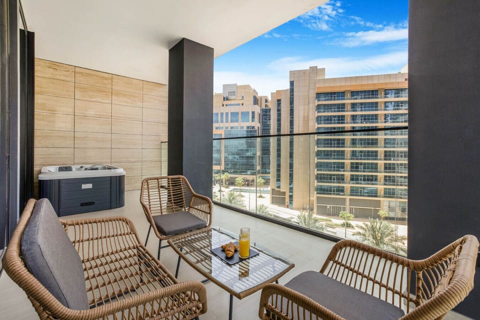 Balcony with jacuzzi and comfy seating.