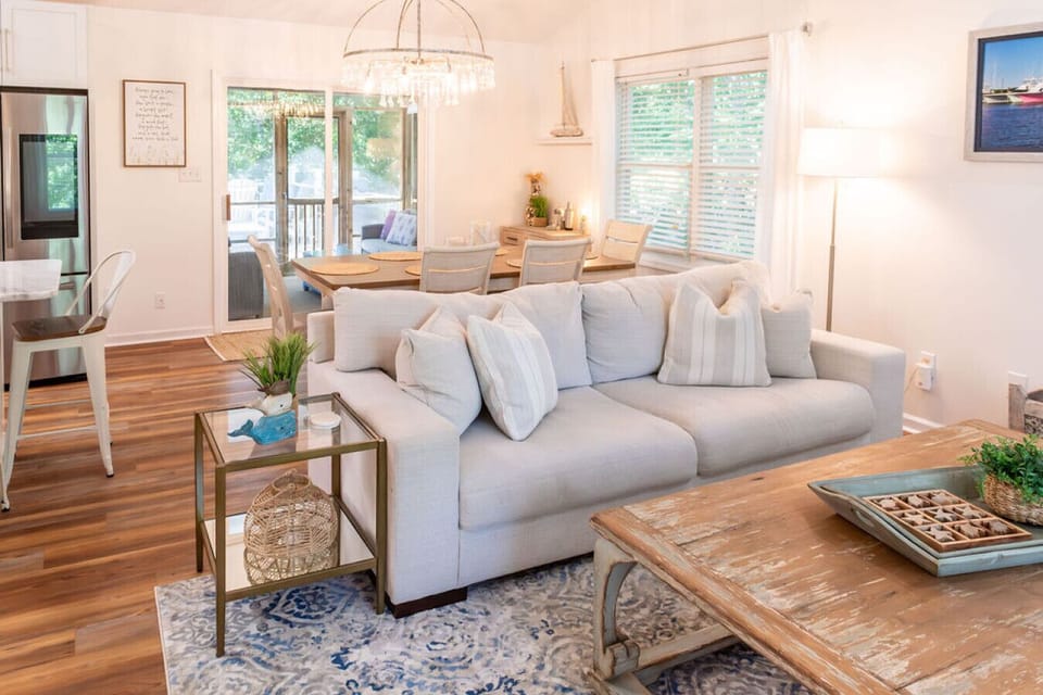 Bright open-concept living and dining area with stylish coastal decor