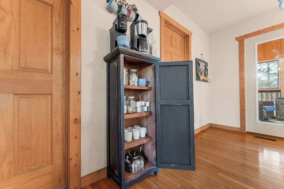 Enjoy this charming coffee and beverage station at our cozy cabin, perfect for a holiday getaway in Branson, MO. Conveniently located near Forest Lake and just minutes from Silver Dollar City in Branson, MO, it’s an inviting space to start or end your day.