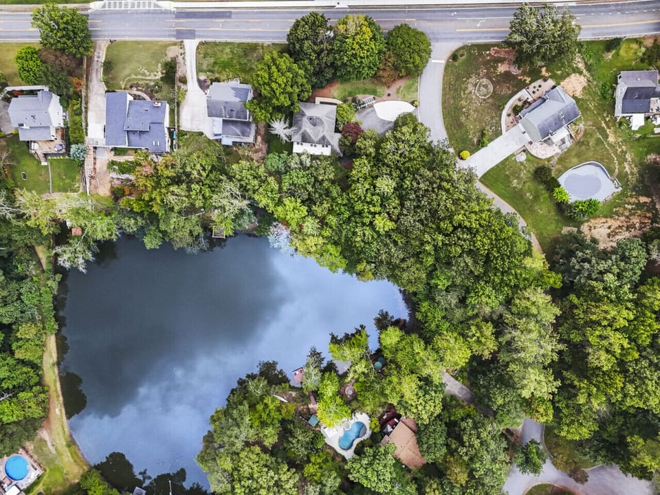 Aerial View | Serene Lakeside Neighborhood Surrounded by Lush Greenery