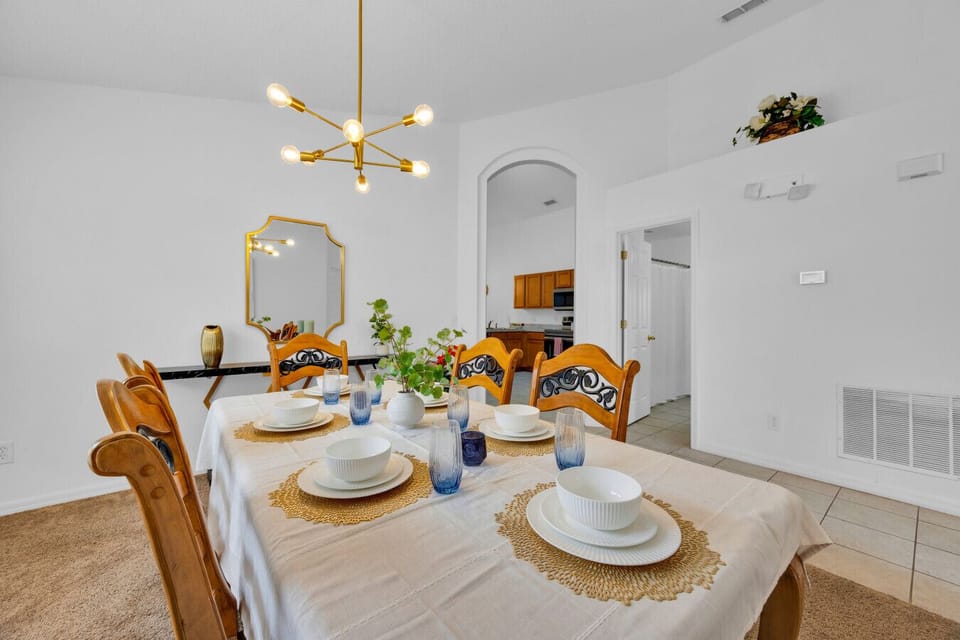 Dining Room | Formal dining area with seating for six, modern light fixture, and decorative accents