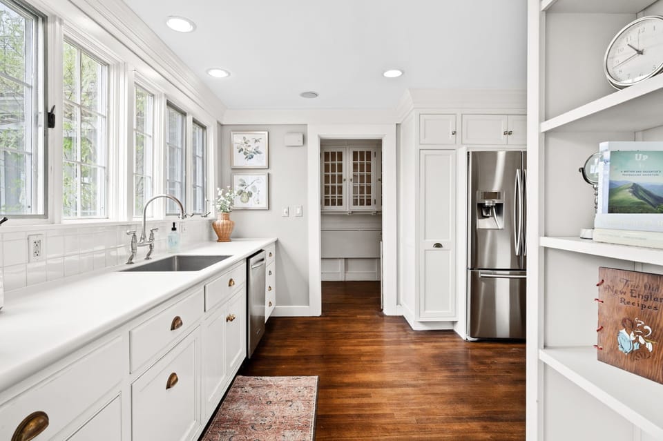 Classic kitchen with hardwood floors, stone counters, and steel apps