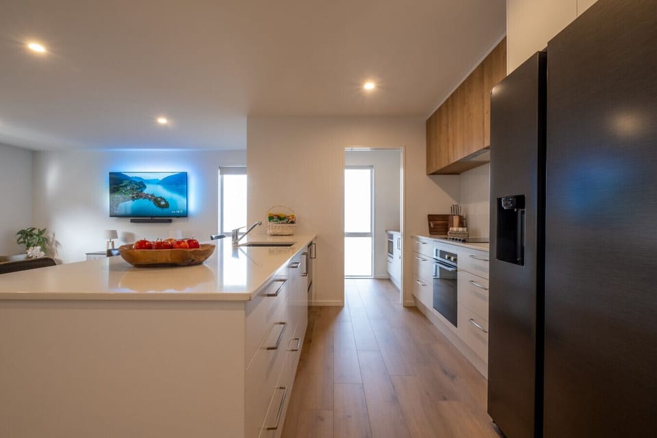 Gather your family in your sleek kitchen and cook together under warm lighting, with your island as the perfect gathering spot.