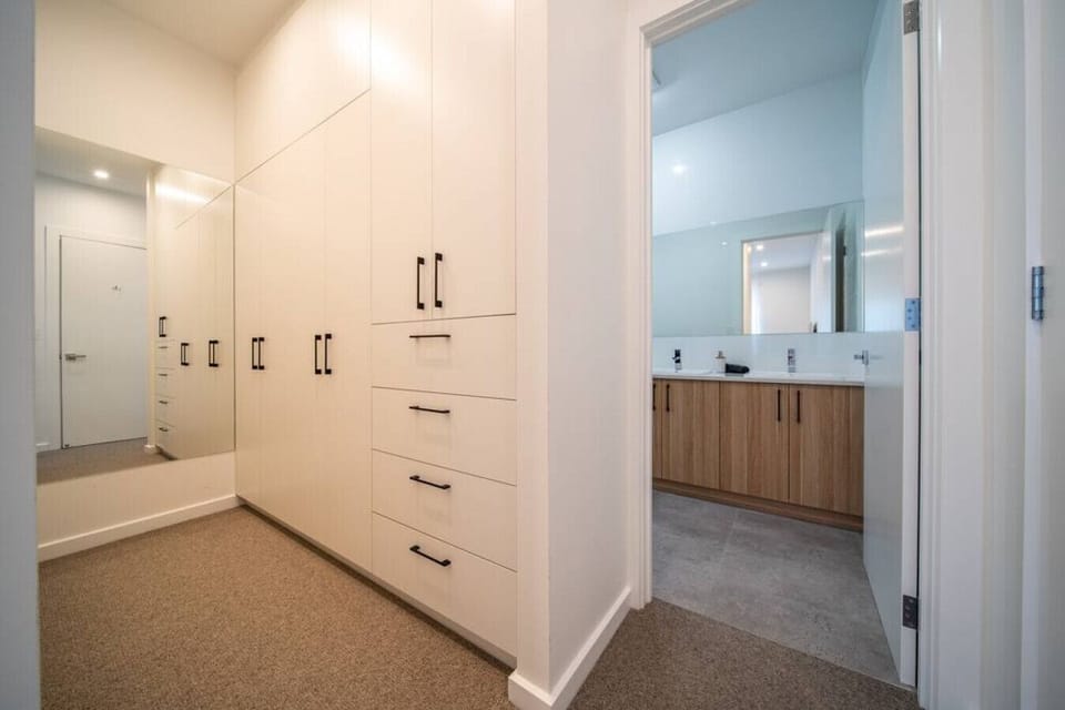 A spacious walk-in wardrobe offers plenty of room to settle in and keep everything neatly organised during your stay.