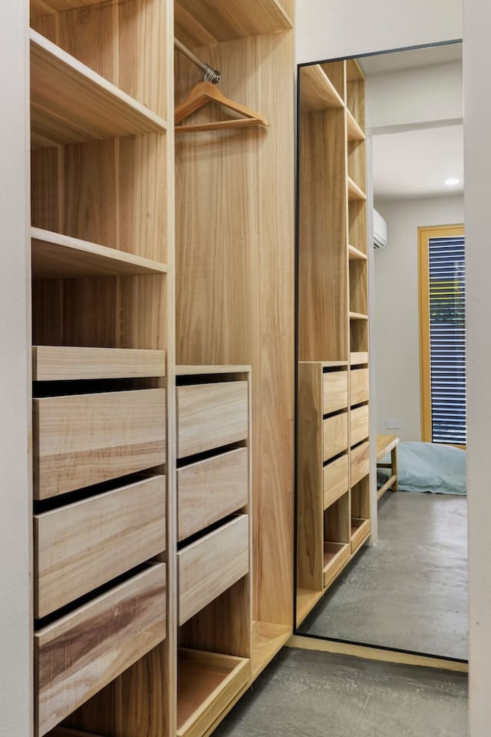 Spacious, sleek, and full of warm wood tones—this walk-in closet is perfect for settling in and feeling right at home.