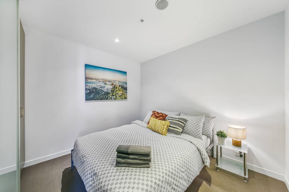 The 2nd bedroom with a queen sized bed & plush pillows.