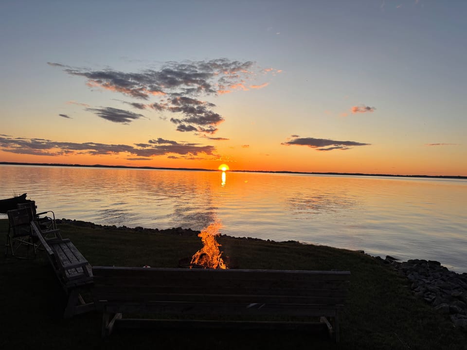 Fire pit by the lake with panoramic views.