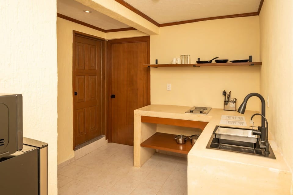 Fully equipped kitchen, perfect for preparing meals during your stay. Includes stove, refrigerator, microwave, kettle, French press, and all basic cookware and utensils.