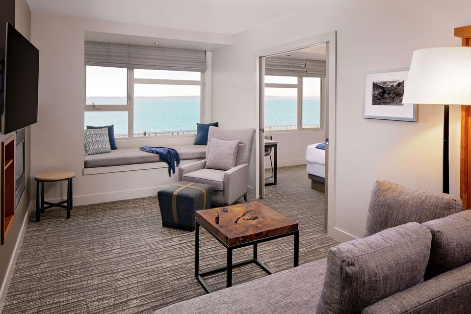 Suite, 1 Bedroom, Bay View | Living area | 55-inch flat-screen TV with cable channels, TV, fireplace